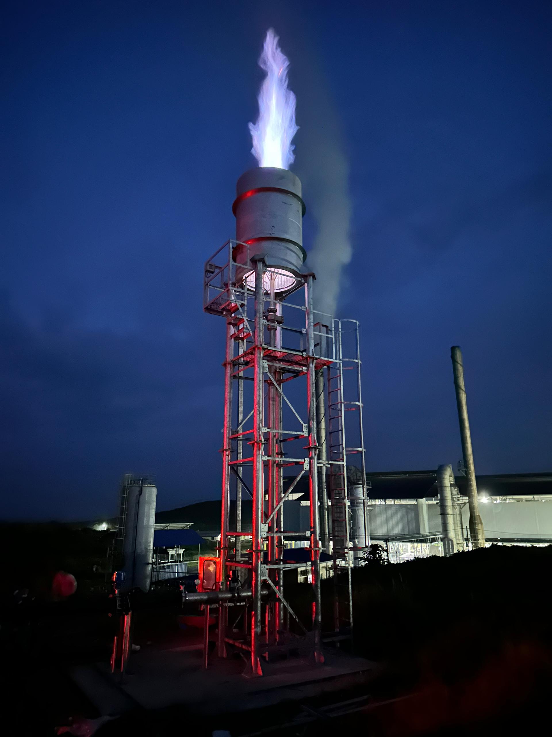 THAGO biogas flare stack at night